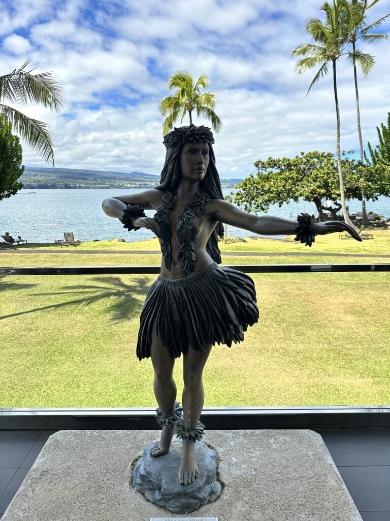 a statue of a woman in a skirt and grass skirt