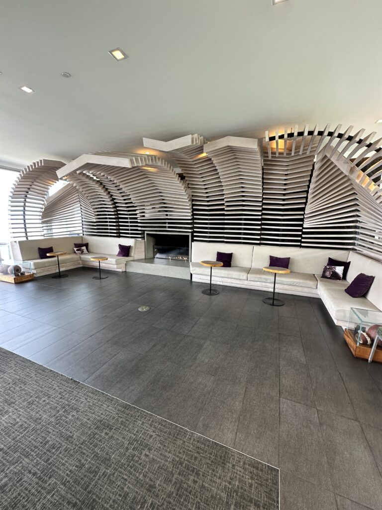 a room with a curved ceiling and a large window