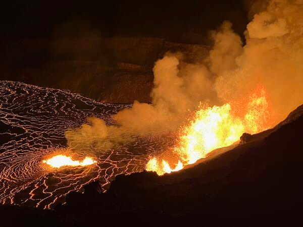 a volcano erupting at night