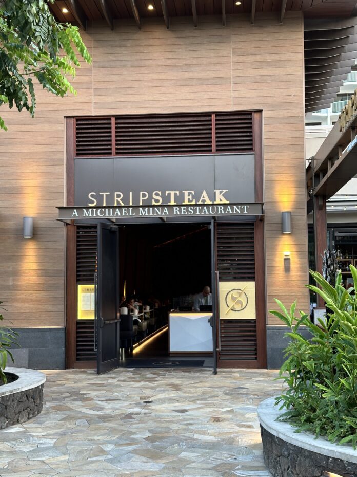 a restaurant entrance with a sign