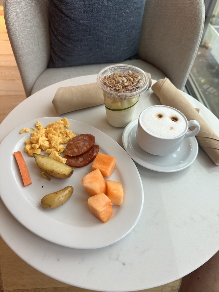 a plate of food and a cup of coffee on a table