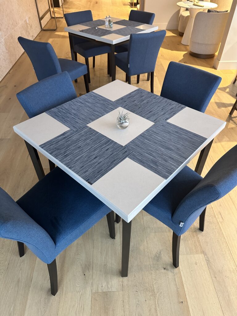 a table with blue chairs around it