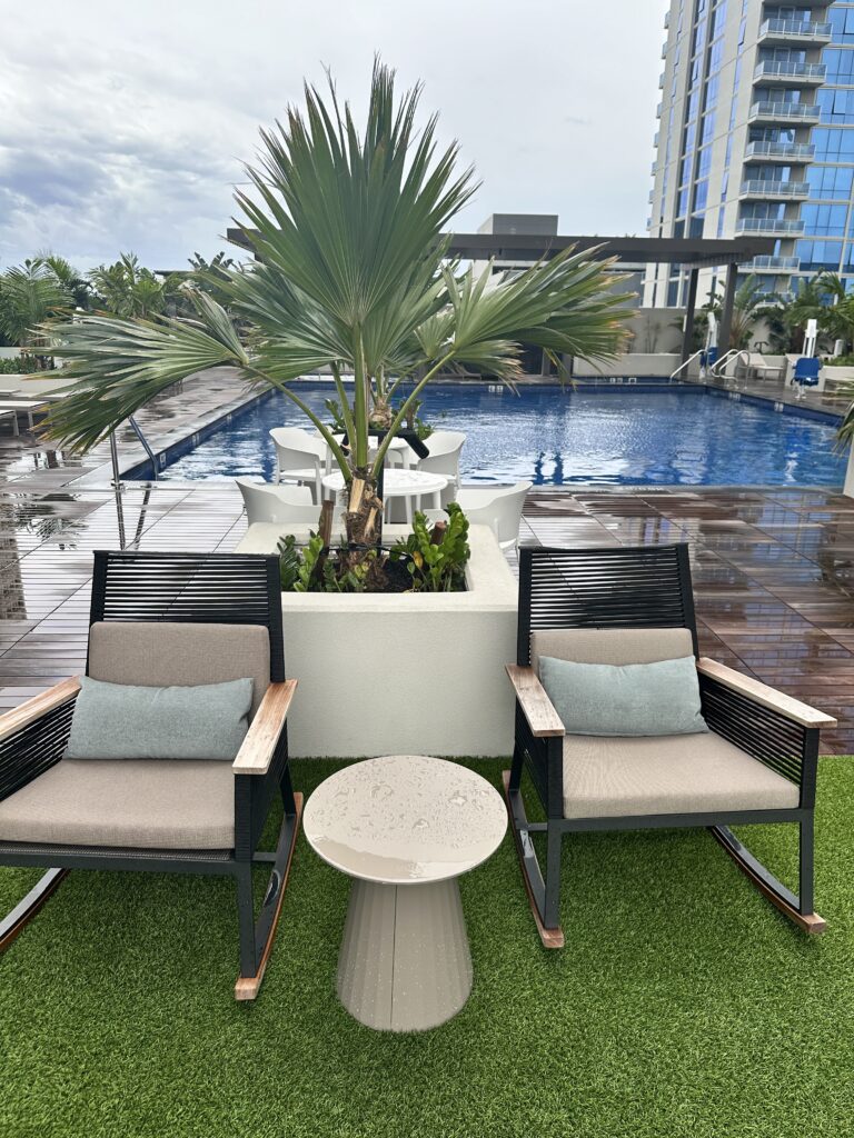 chairs and a table by a pool