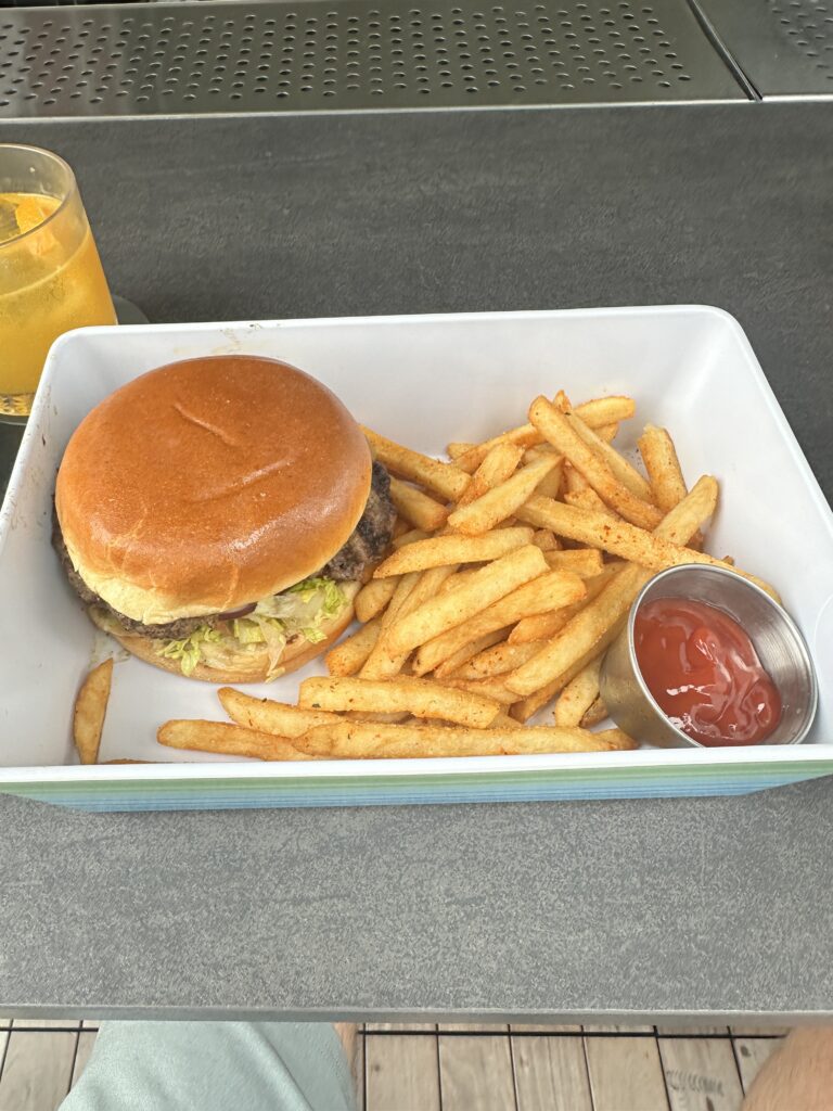 a burger and fries in a white container