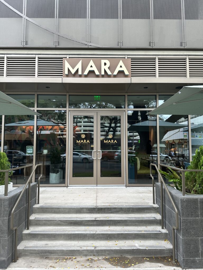 a building with glass doors and a sign