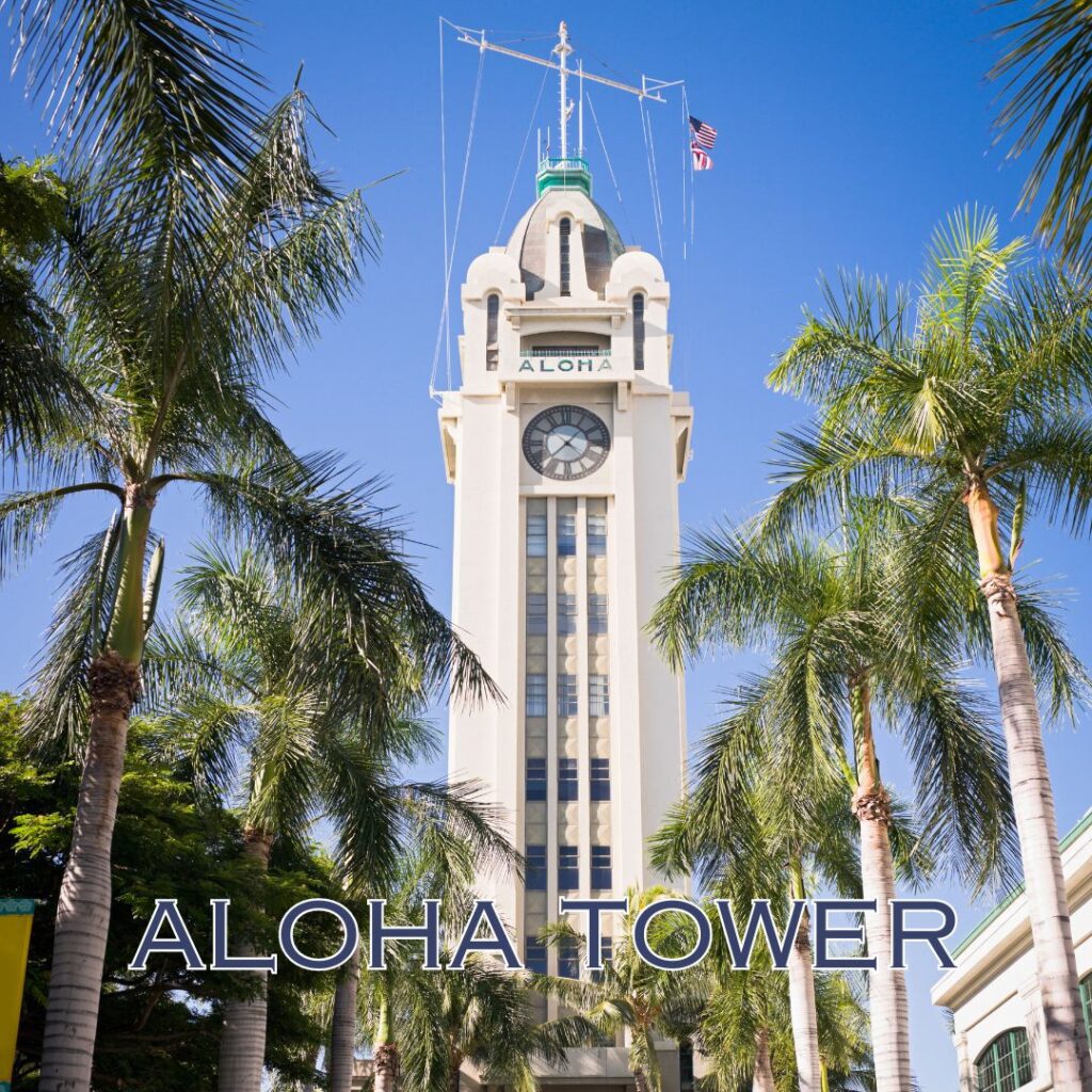 a tall white tower with a clock on top with Aloha Tower in the background