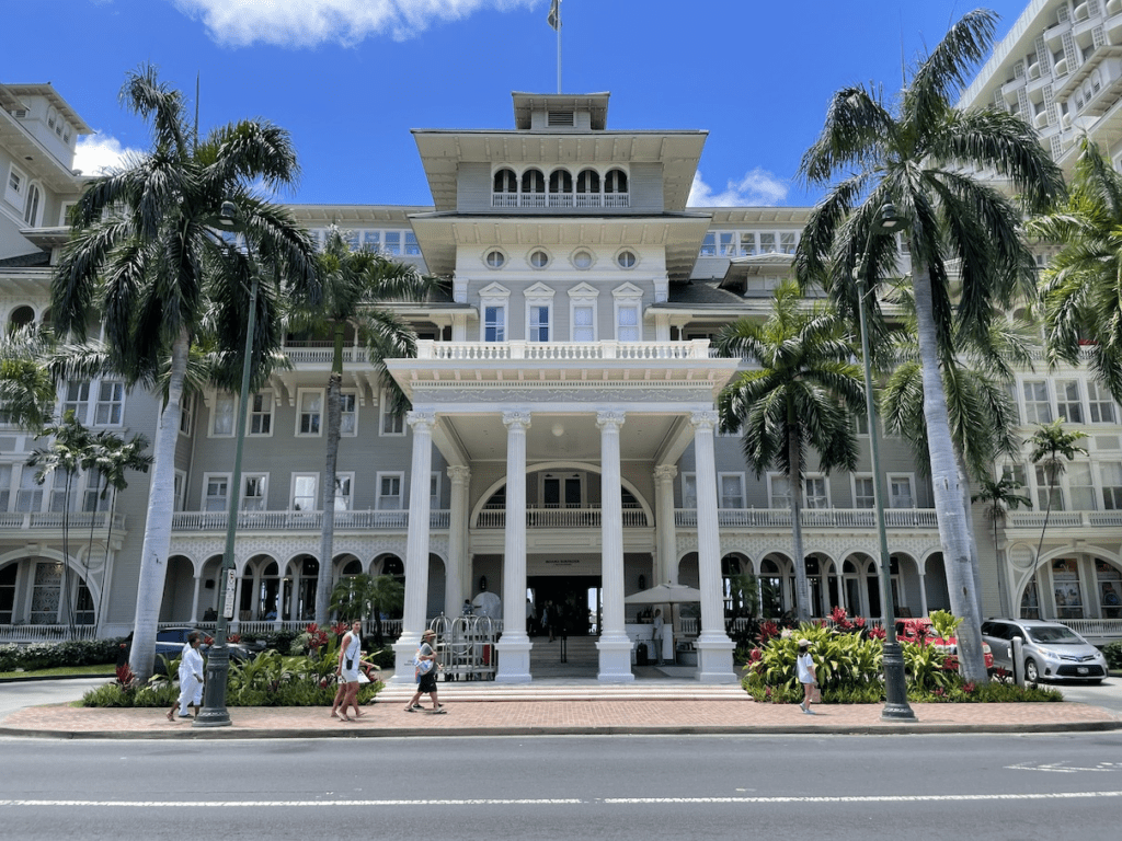 a large building with columns and columns with Iolani Palace in the background