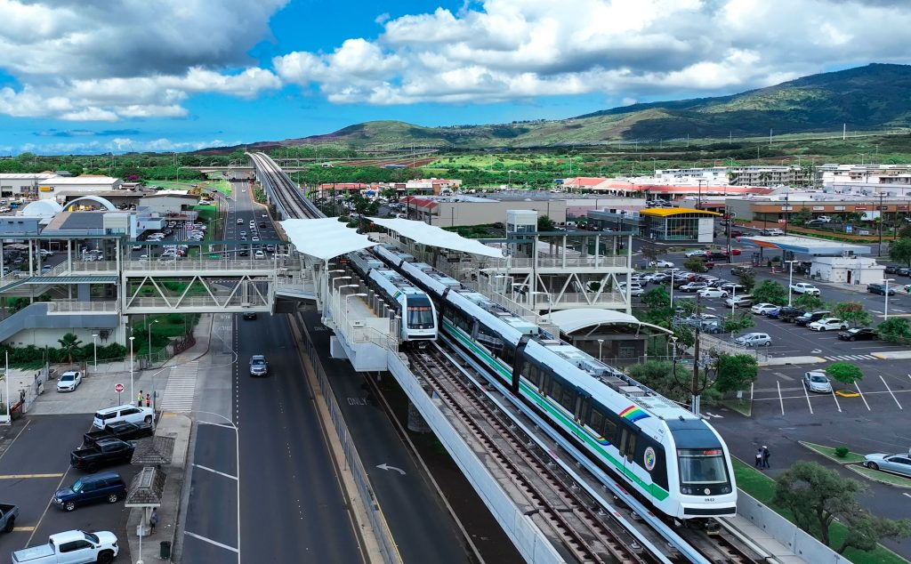 a train on a bridge over a road