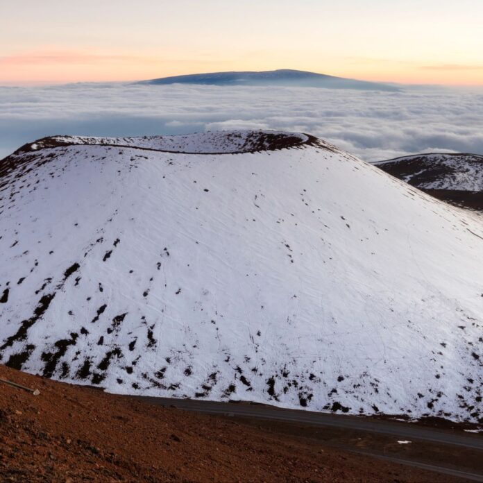 a snow covered mountain top of Mauna Kea making it one of the best islands to visit in Hawai'i in january