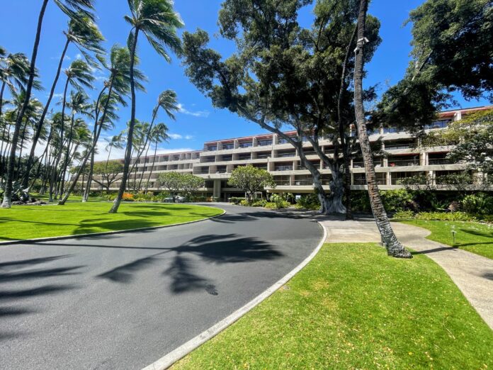 a road leading to Mauna Kea Beach Hotel Main Entrance