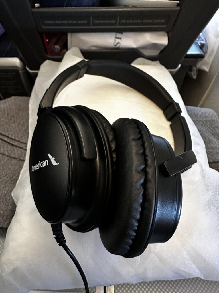 a black headphones on a white surface