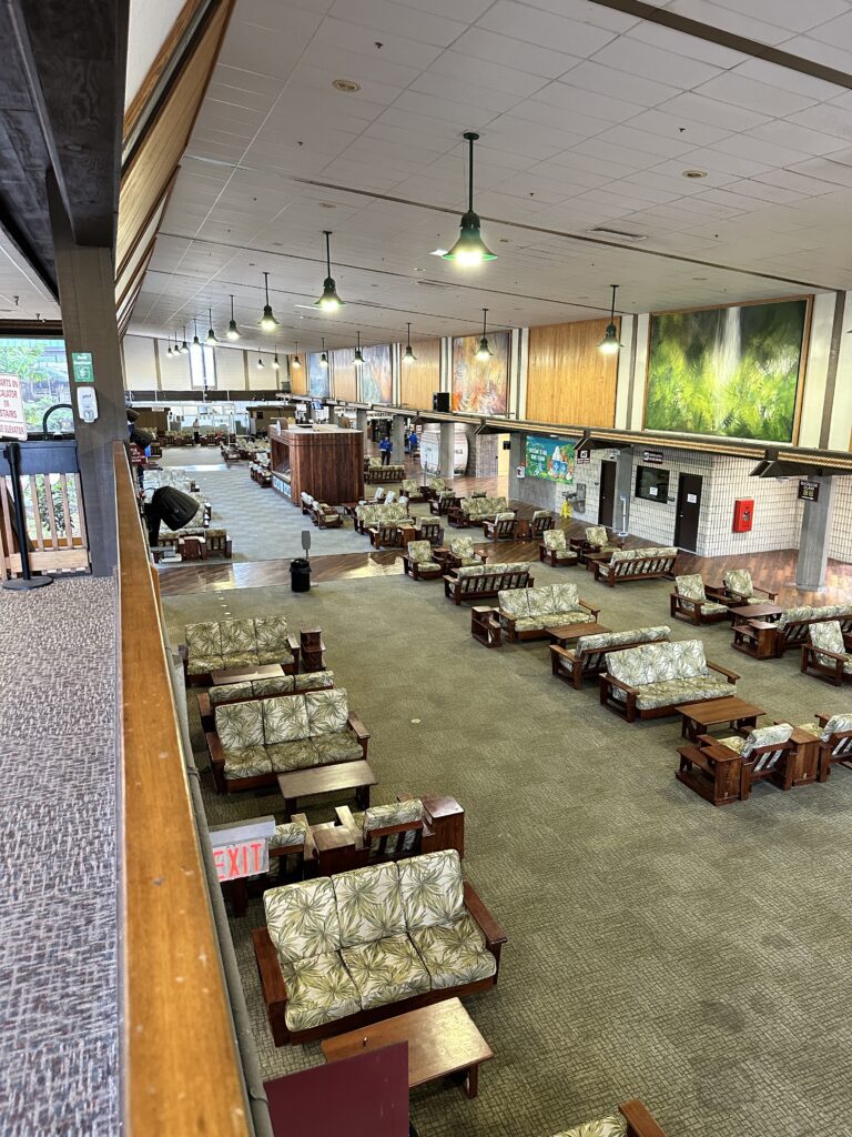 a room with couches and chairs in the hilo international airport guide