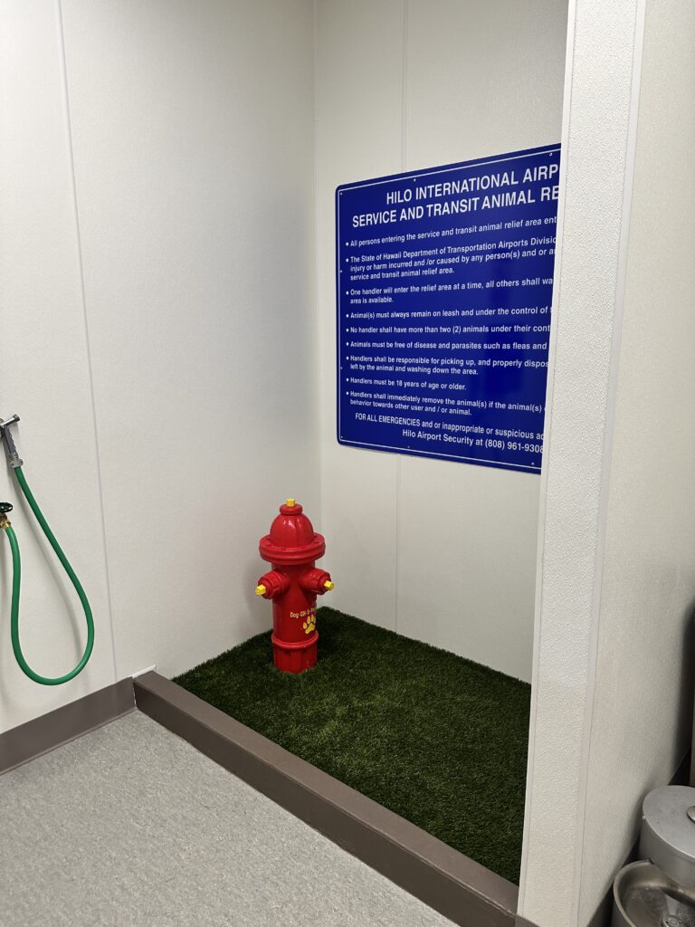 a red fire hydrant in a room with a sign