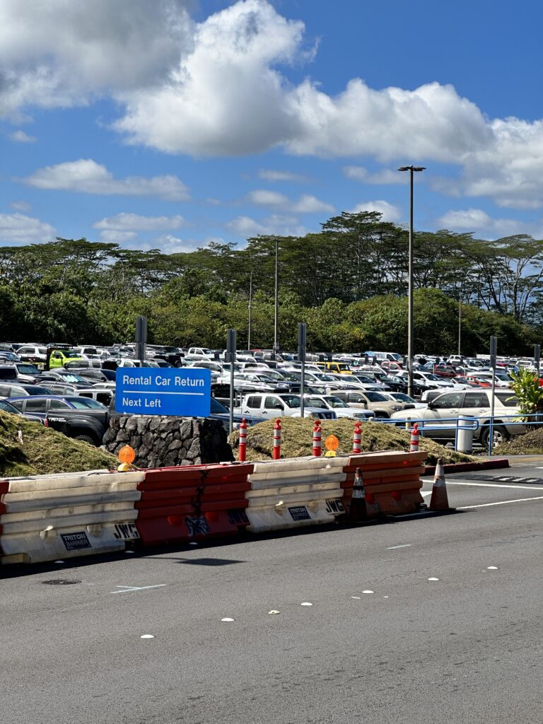 a parking lot with a sign and a road