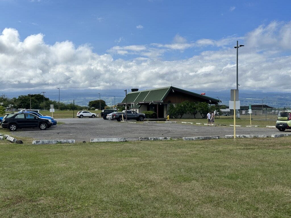 a building with a parking lot and cars