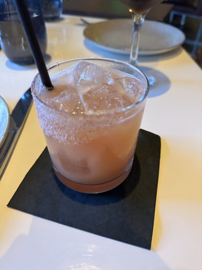 a glass with a drink and a straw