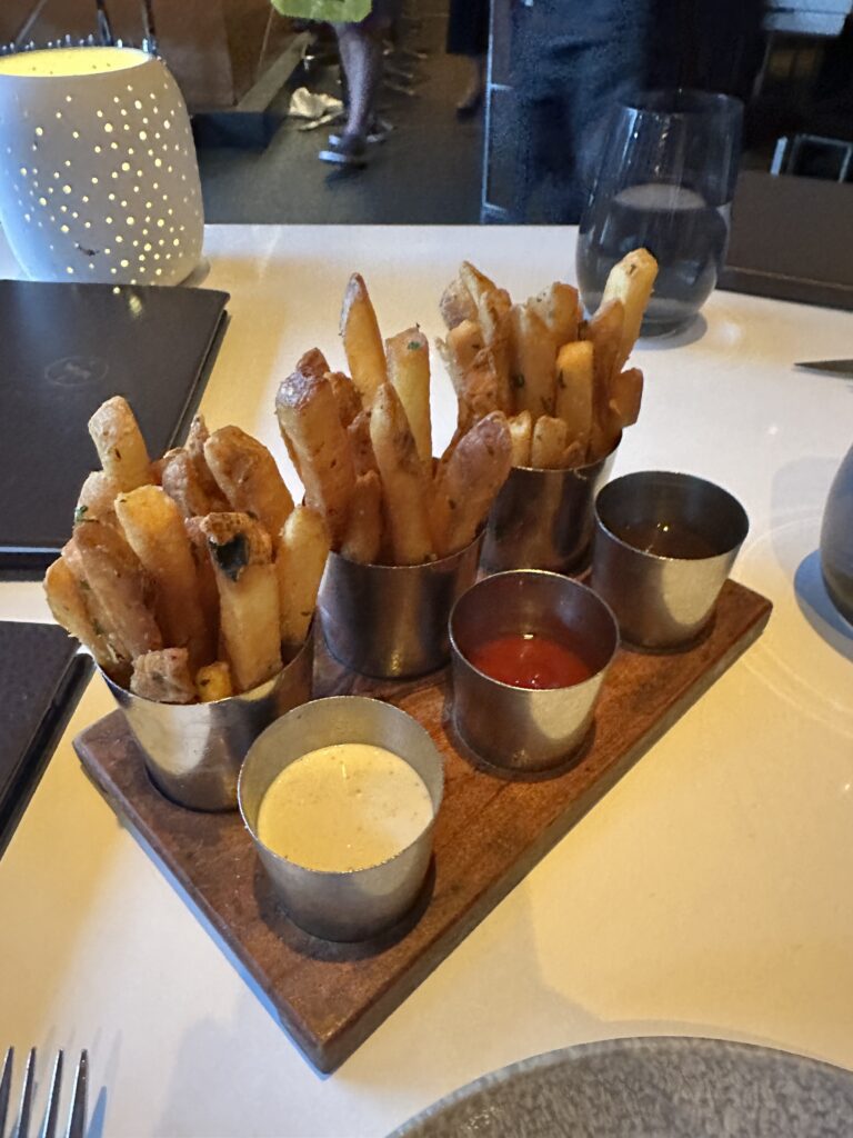 a tray of french fries and sauces