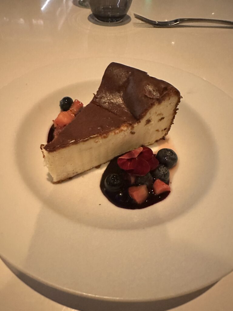 a slice of cheesecake with fruit on a plate