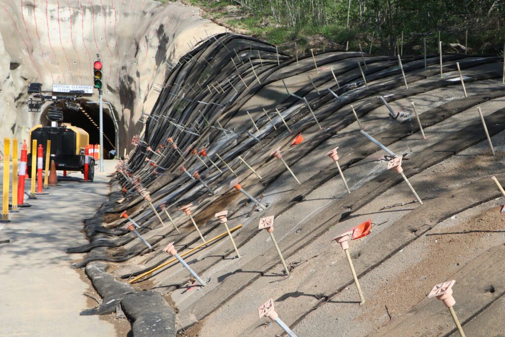 a road under construction with a tunnel