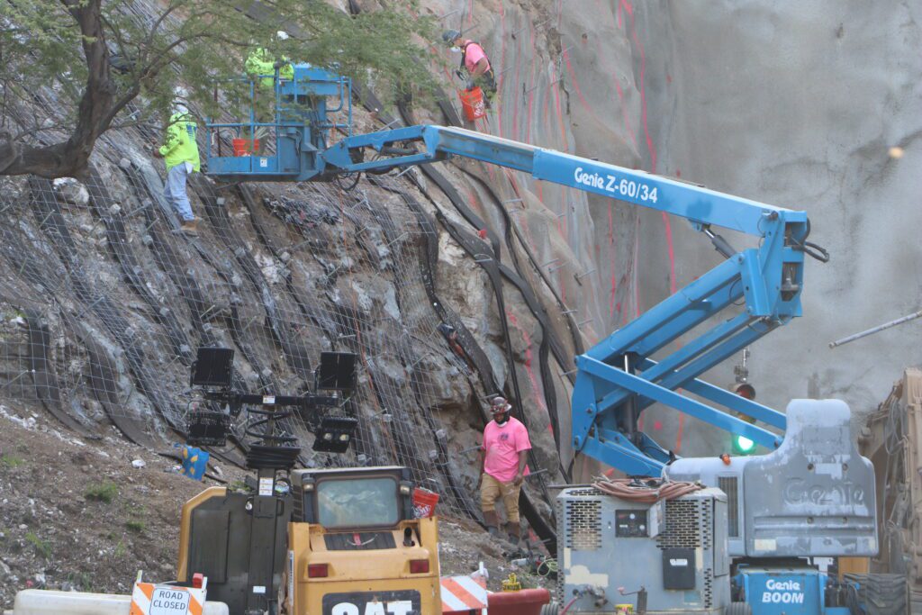 a group of people working on a mountain side