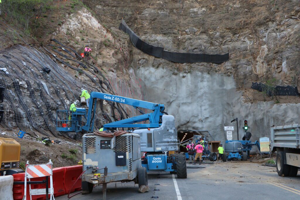 a construction site with a crane and trucks