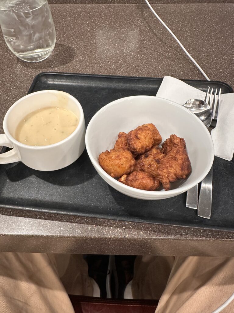 a tray with food and a cup of soup