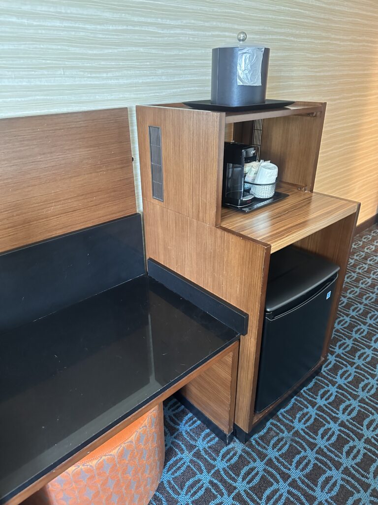 a wooden shelf with a black counter top