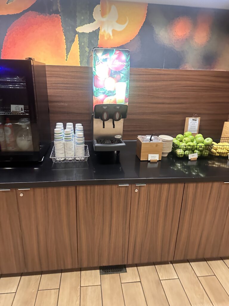 a counter with fruit and juice dispenser