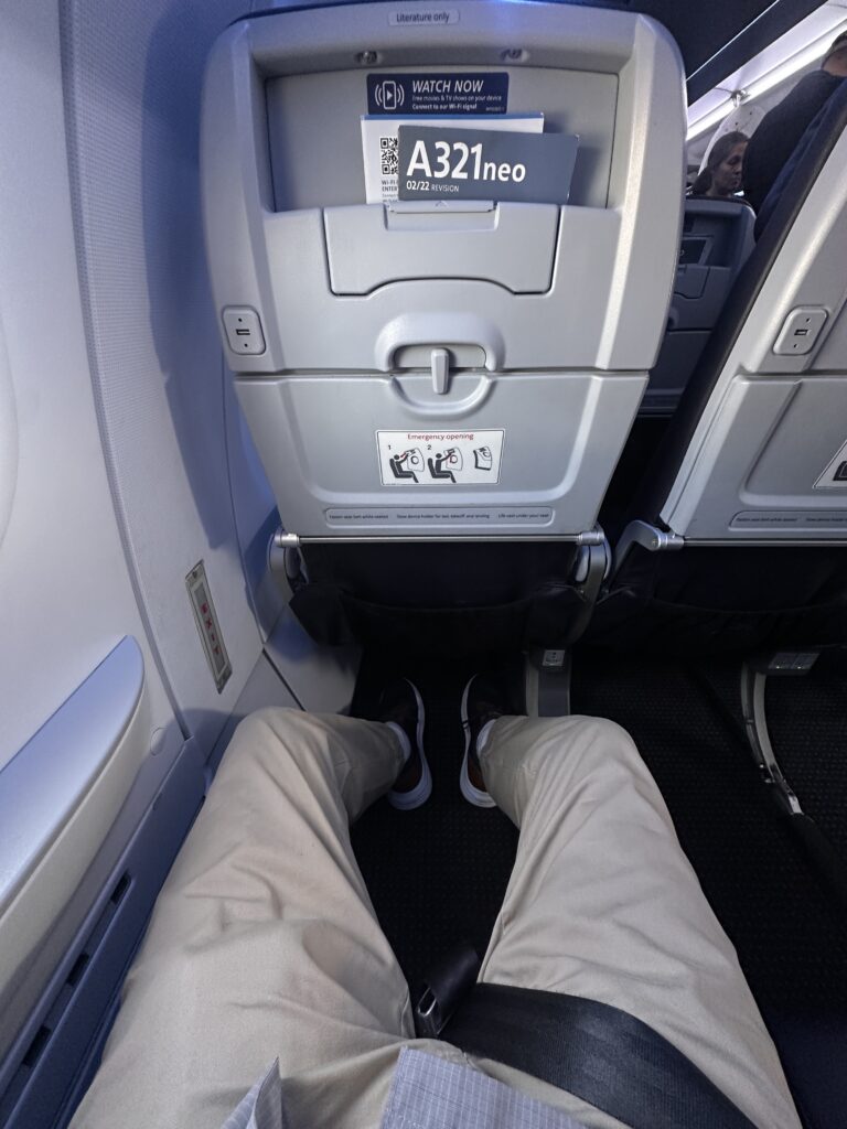 a person's legs in a plane