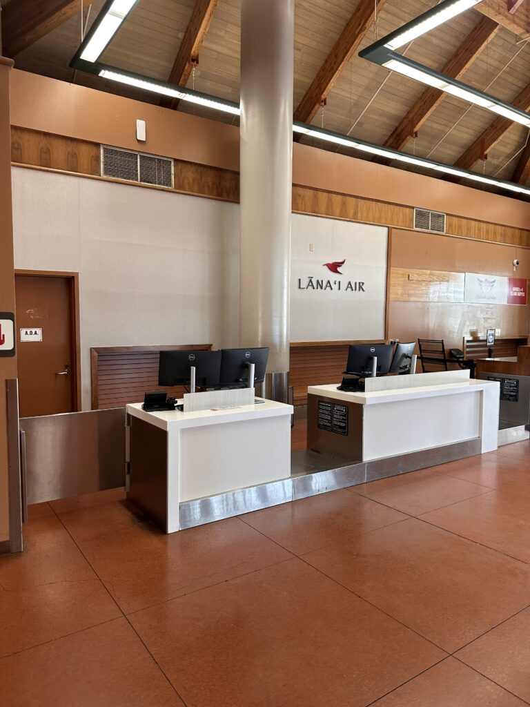 a reception area with computers and a large white column