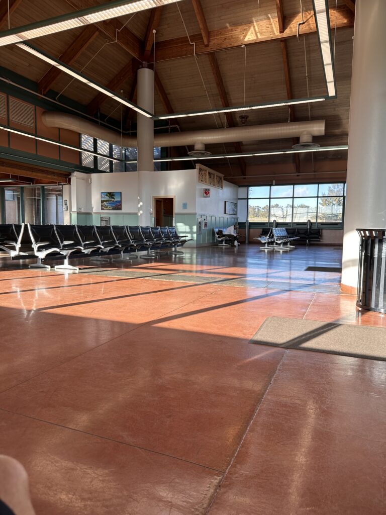 a large room with chairs and a large window Lānaʻi Airport Terminal