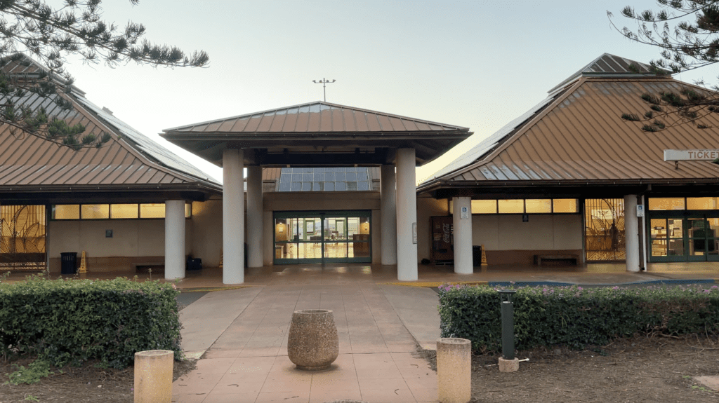 a building with a large stone pot and a stone vase